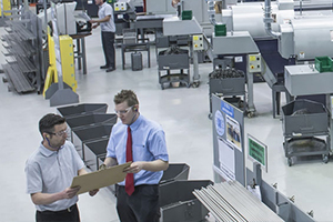 two machinist conversating in machine shop