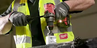 man using a Miwaukee M12 tool