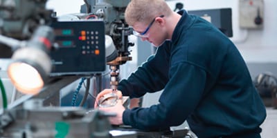 image of man working with metalworking machine
