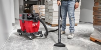 worker using a Milwaukee wet/dry vacuum