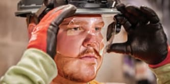 worker putting on eye protection