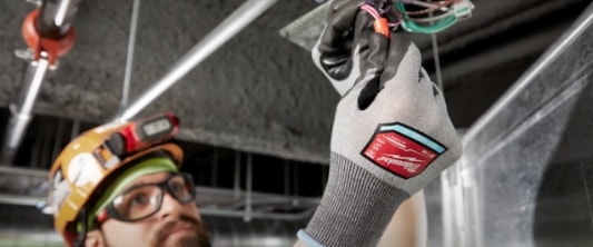 man working with Milwaukee safety gloves on
