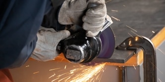 worker cutting metal with 3M Cubitron 3 bonded wheels