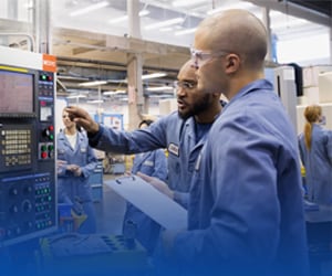 Two men discussing machine work