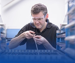 Worker looking at a tool from inventory