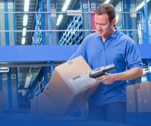 Worker scanning a package to ship