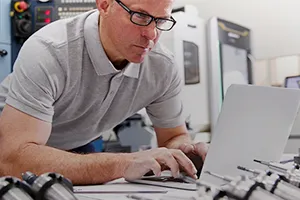machinist working on a laptop