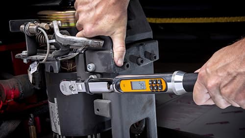 image of man using an electronic torque wrench