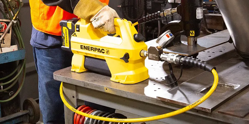 a worker using the Enerpac SC hydraulic pump
