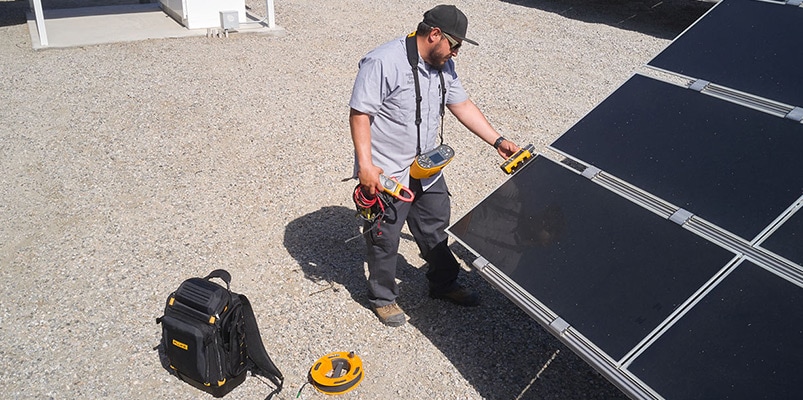 man testing solar panels