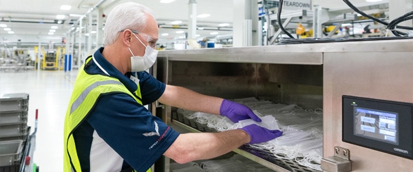 Male worker uses cost control software to manage inventory at workplace