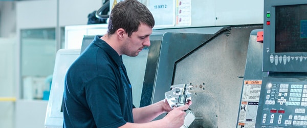 Metal industry worker analyzes operations for retooling operations