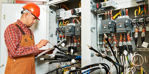 man testing electrical box